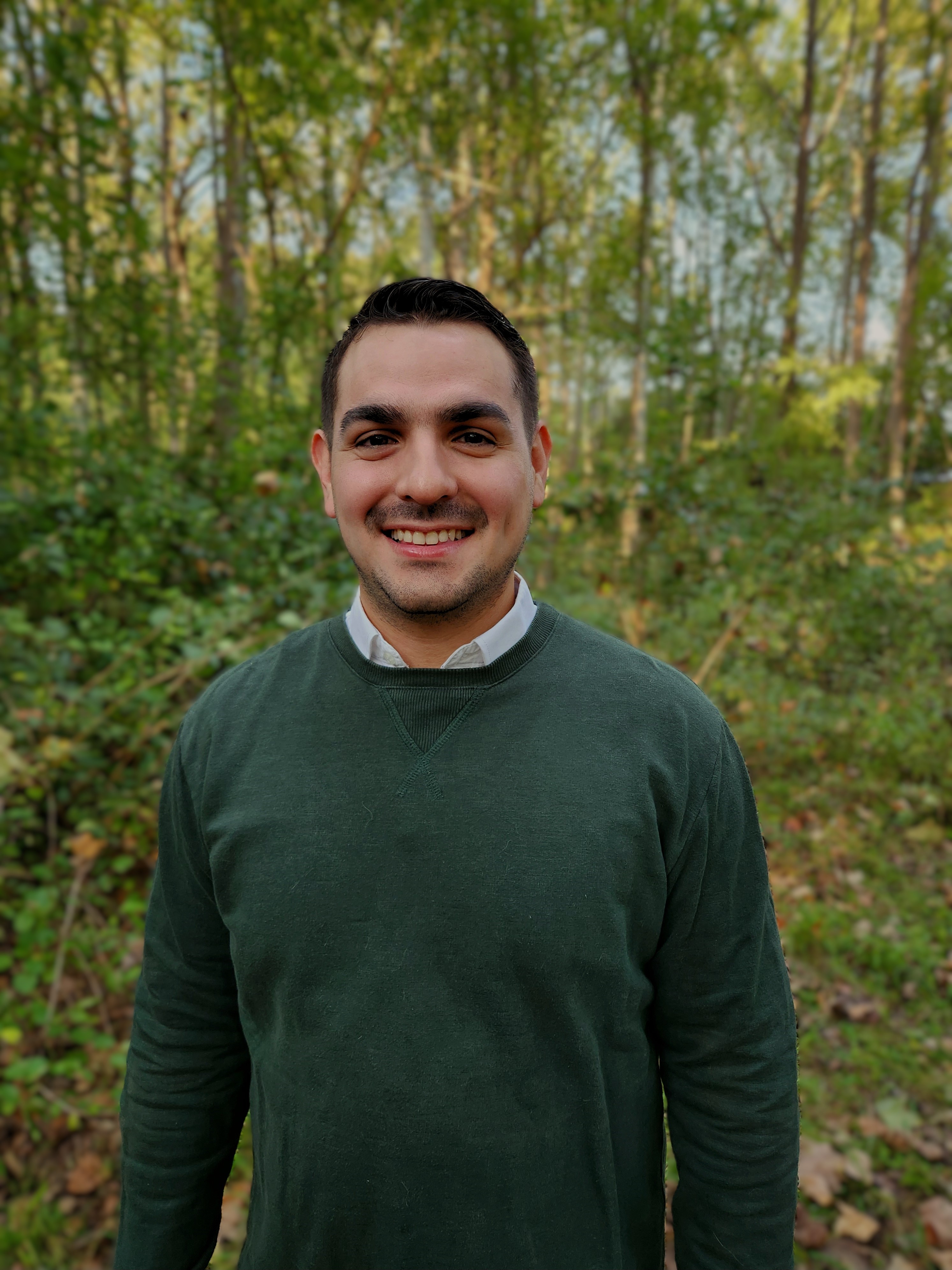 Photo of Jose R. Pittaluga, Ph.D. outdoors with trees in the background