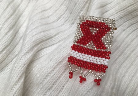 Beaded AIDS Awareness ribbon pin on knit scarf