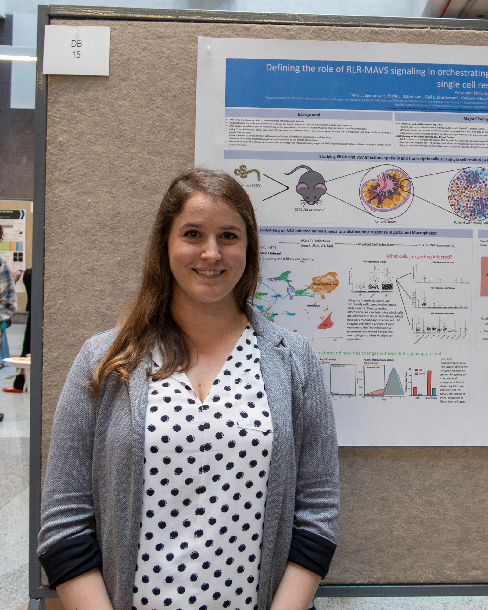 Emily Speranza standing in front of a poster