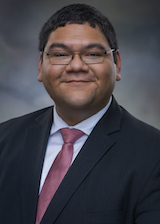 A headshot of Janitzio Guzman in a suit and a tie. 