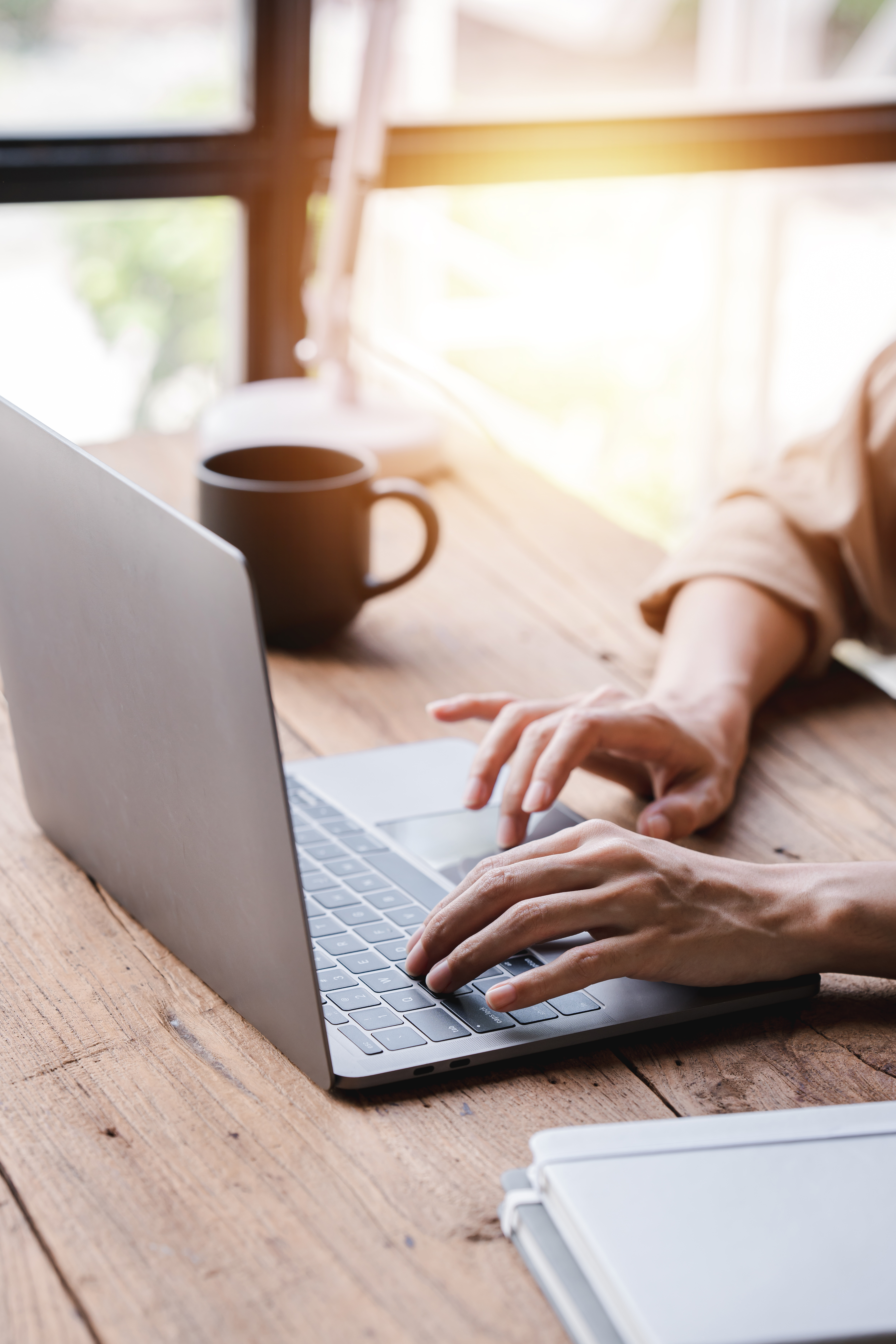 Hands typing on laptop