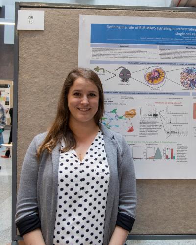 Emily Speranza standing in front of a poster