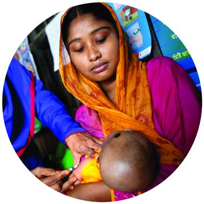 woman holding her baby while baby gets vaccinated