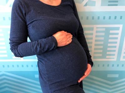 A pregnant woman in a blue dress