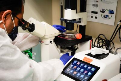 NIAID researcher uses an electron microscope.