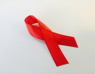 A folded red ribbon against a white background.