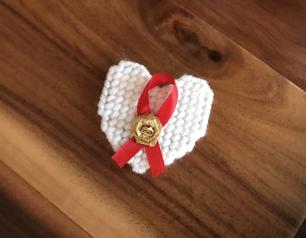 Red AIDS Awareness Ribbon and white Pin of Remembrance