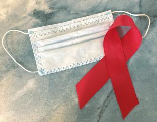 A surgical mask and an HIV/AIDS awareness ribbon.