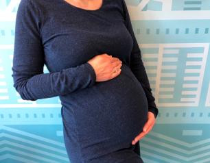 A pregnant woman in a blue dress