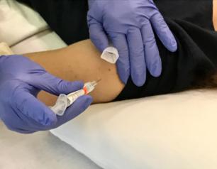 Volunteer in trial of candidate universal flu vaccine BPL-1357 receives an intramuscular injection.