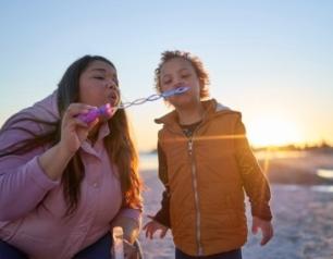 mother and baby blowing bubbles