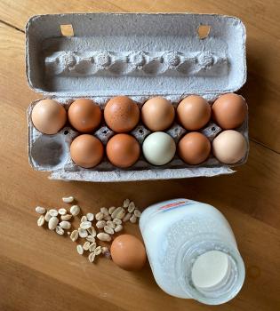 A photo of eggs, milk, and peanuts
